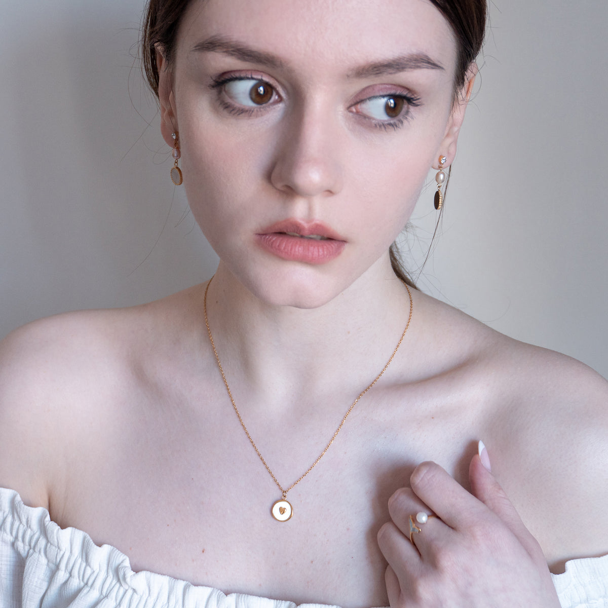 Amarelle Nido necklace worn by model, expressing a soft and protective presence