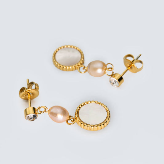 Close-up of Amarelle Scala earrings with crystal, pearl and shell-mica elements